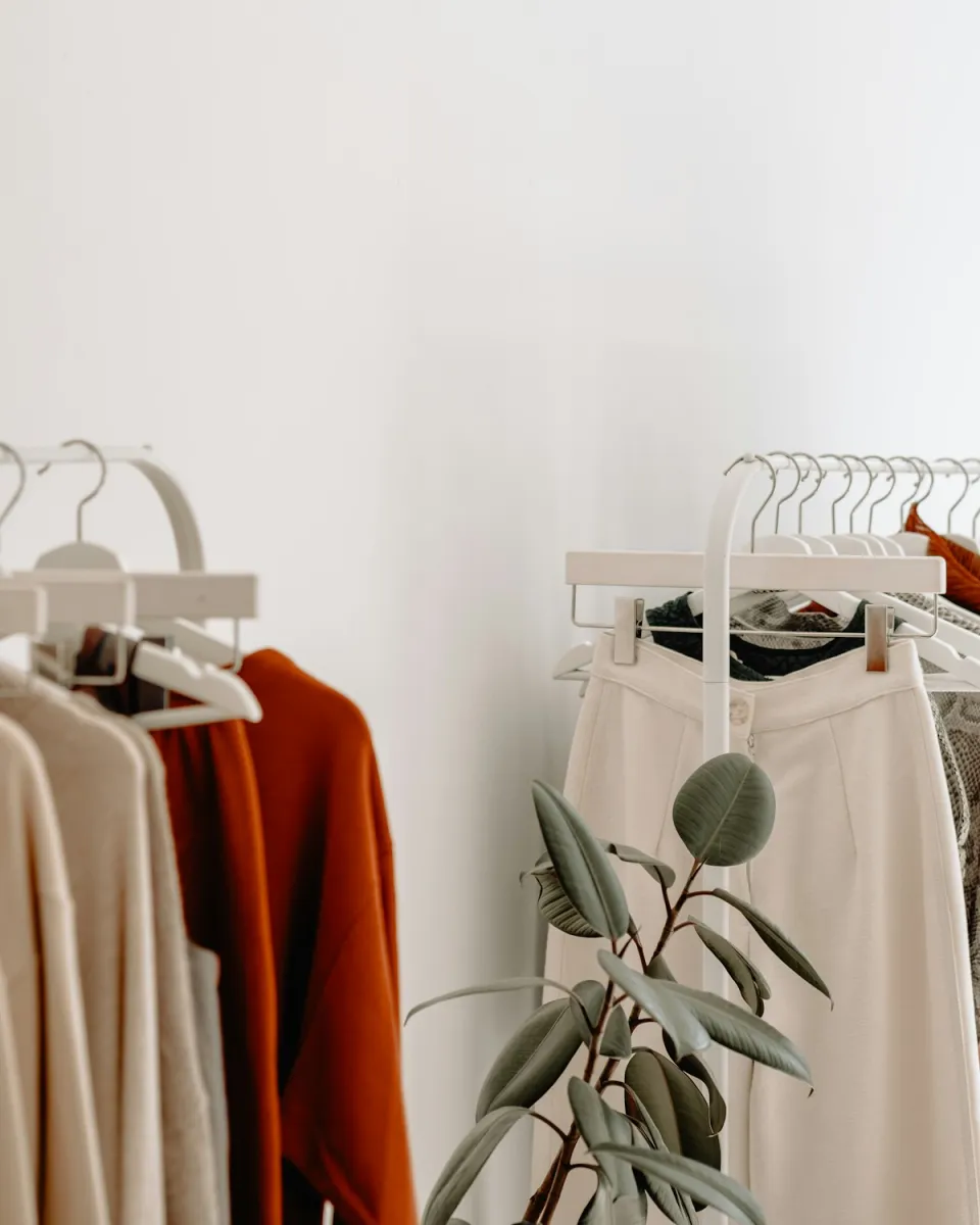 Neutral-toned garments on a clothing rail